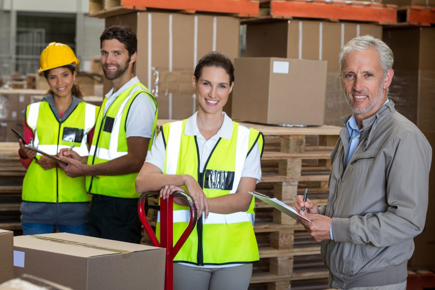 portrait of warehouse manager and workers preparing a shipment